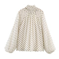 Blusa de lunares con cuello alto